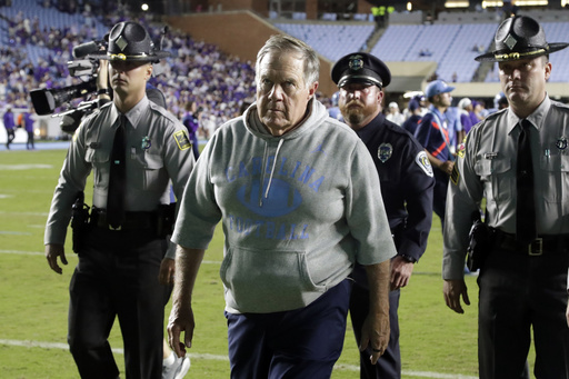 North Carolina head coach Bill Belichick, front, walks off the field after his team lost to TCU in an NCAA college football game Monday, Sept. 1, 2025, in Chapel Hill, N.C. (AP Photo/Chris Seward)