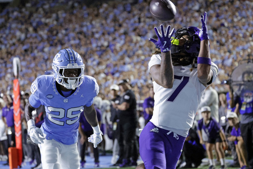 TCU wide receiver Jordan Dwyer (7) hauls in a touchdown pass over North Carolina defensive back Marcus Allen (29) during the first half of an NCAA college football game Monday, Sept. 1, 2025, in Chapel Hill, N.C. (AP Photo/Chris Seward)