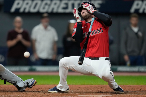 CORRECTION CORRECTS HITTING ON THE FACE BY PITCH - Cleveland Guardians' David Fry falls back after being hit in the face by a pitch in the sixth inning of a baseball game against the Detroit Tigers in Cleveland, Tuesday, Sept. 23, 2025. (AP Photo/Sue Ogrocki)
