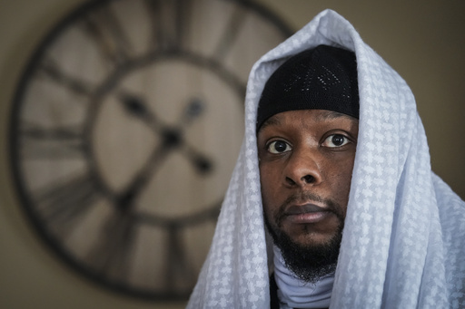 FILE - Myon Burrell poses for a photo at his home in Minneapolis, Dec. 17, 2020, two days after his release from prison. (AP Photo/John Minchillo, File)