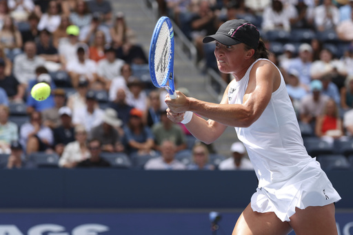 Iga Swiatek, of Poland, returns a shot against Ekaterina Alexandrova, of Russia, during the fourth round of the US Open tennis championships, Monday, Sept. 1, 2025, in New York. (AP Photo/Heather Khalifa)