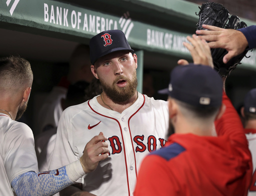Boston Red Sox pitcher Garrett Crochet is congratulated in the dugout after the seventh inning of a baseball game against the New York Yankees, Sunday, Sept. 14, 2025, in Boston. (AP Photo/Jim Davis)