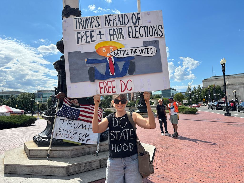 A woman holds a sign outside Union Station in Washington, D.C.