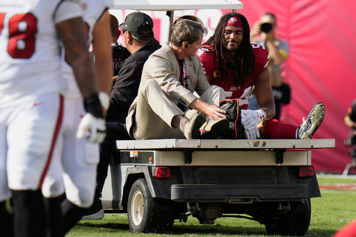 San Francisco 49ers middle linebacker Fred Warner, right, is carted off the field during the first half of an NFL football game against the Tampa Bay Buccaneers in Tampa, Fla., Sunday, Oct. 12, 2025. (AP Photo/Chris O'Meara)
