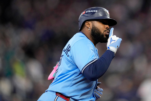 Toronto Blue Jays' Vladimir Guerrero Jr. celebrates his solo home run against the Seattle Mariners during the fifth inning in Game 3 of baseball's American League Championship Series, Wednesday, Oct. 15, 2025, in Seattle. (AP Photo/David J. Phillip)