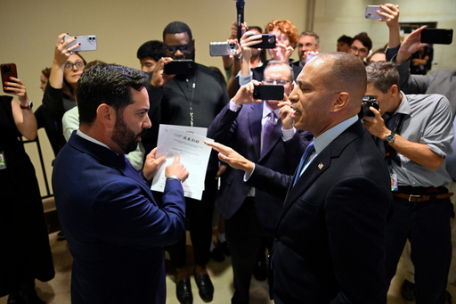 Rep. Michael Lawler, R-N.Y., left, confronts House Minority Leader Hakeem Jeffries, D-N.Y., in a heated discussion to endorse House bill H.R.5145 that would extend the American Rescue Plan Act of 2021 (ARPA) and the Inflation Reduction Act of 2022 at the U.S. Capitol on Wednesday, Oct. 8, 2025, in Washington. (AP Photo/John McDonnell)