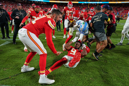 Detroit Lions defensive back Brian Branch (32) fights with Kansas City Chiefs wide receiver JuJu Smith-Schuster (9) while be held back by Chiefs' James Winchester, left, and Isiah Pacheco (10) following an NFL football game Sunday, Oct. 12, 2025, in Kansas City, Mo. (AP Photo/Ed Zurga)