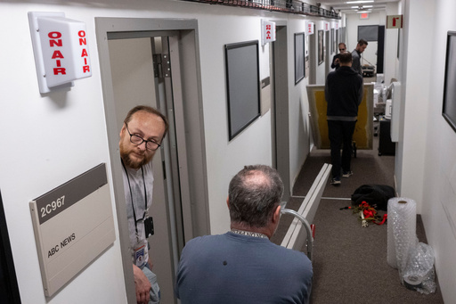 Members of the media pack up their belongings in the press area of the Pentagon, Wednesday, Oct. 15, 2025 in Washington. (AP Photo/Kevin Wolf)
