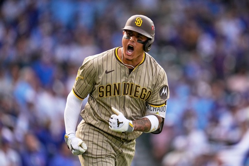 San Diego Padres' Manny Machado is reacts after hitting a two-run home run during the fifth inning of Game 2 of a National League wild card baseball game Wednesday, Oct. 1, 2025, in Chicago. (AP Photo/Erin Hooley)