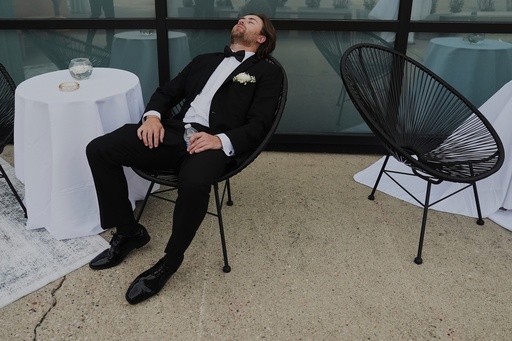 FILE - A Groomsman takes a break after finishing bridal party photos at a wedding on Saturday, Aug. 23, 2025, in Newtown, Ohio. (AP Photo/Joshua A. Bickel, File)