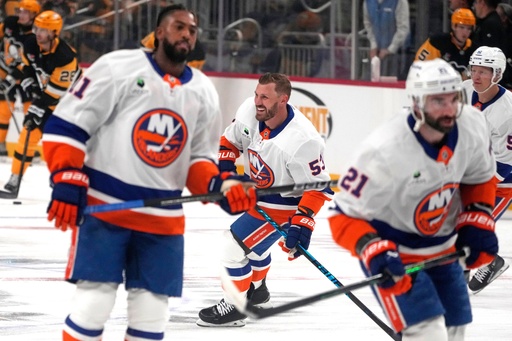 New York Islanders' Casey Cizikas, center, Anthony Duclair, left, and Kyle Palmieri (21) skate during warm ups before an NHL hockey game against the Pittsburgh Penguins in Pittsburgh, Thursday, Oct. 9, 2025. (AP Photo/Gene J. Puskar)