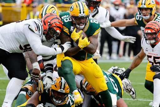 Green Bay Packers running back Josh Jacobs (8) scores a touchdown against the Cincinnati Bengals in the first half of an NFL football game, Sunday, Oct. 12, 2025, in Green Bay, Wis. (AP Photo/Mike Roemer)