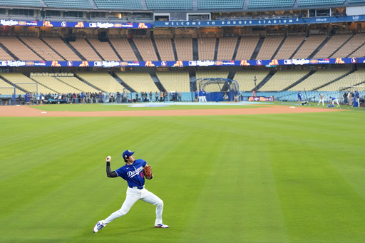 Los Angeles Dodgers' Shohei Ohtani works out ahead of Game 3 of the 2025 World Series against the Toronto Blue Jays in Los Angeles, Sunday, Oct. 26, 2025. (AP Photo/Ashley Landis)