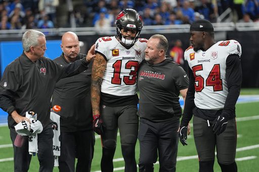 Tampa Bay Buccaneers wide receiver Mike Evans (13) is helped off the field after an injury during the first half of an NFL football game against the Detroit Lions, Monday, Oct. 20, 2025, in Detroit. AP Photo/Paul Sancya)