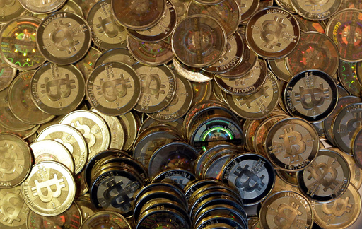 FILE - This April 3, 2013, file photo shows bitcoin tokens in Sandy, Utah. (AP Photo/Rick Bowmer, File)