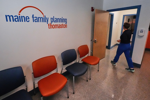 FILE - Vanessa Shields-Haas, a nurse practitioner, walks from the lobby toward the examination rooms at the Maine Family Planning healthcare facility, July 15, 2025, in Thomaston, Maine. (AP Photo/Charles Krupa, File)