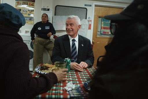 Jersey City mayoral candidate Jim McGreevey, center, listens during a community event on Wednesday, Oct. 29, 2025, in Jersey City, N.J. (AP Photo/Andres Kudacki)