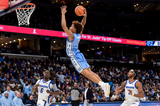 FILE - North Carolina guard Seth Trimble (7) dunks against Memphis during the Hoops for St. Jude Tip Off Classic NCAA college basketball exhibition game Tuesday, Oct. 15, 2024, in Memphis, Tenn. (AP Photo/Brandon Dill, File)