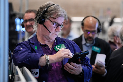 Options trader Brian Garvey, left, works on the floor of the New York Stock Exchange, Monday, Oct. 20, 2025. (AP Photo/Richard Drew)