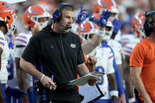 Florida head coach Billy Napier calls in plays to his offense during the first quarter of an NCAA college football game against Texas A&M on Saturday, Oct. 11, 2025, in College Station, Texas. (AP Photo/Sam Craft)
