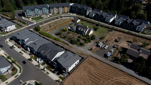 FILE - New construction homes and apartments are seen surrounding an older home on Friday, July 11, 2025, in Happy Valley, Ore. (AP Photo/Jenny Kane, File)