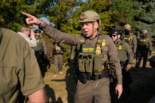 Greg Bovino, the chief patrol agent for the U.S. Border Patrol El Centro sector, center, walks with federal immigration agents near an Immigration and Customs Enforcement facility in Broadview, Ill., Friday, Oct. 3, 2025. (AP Photo/Erin Hooley)