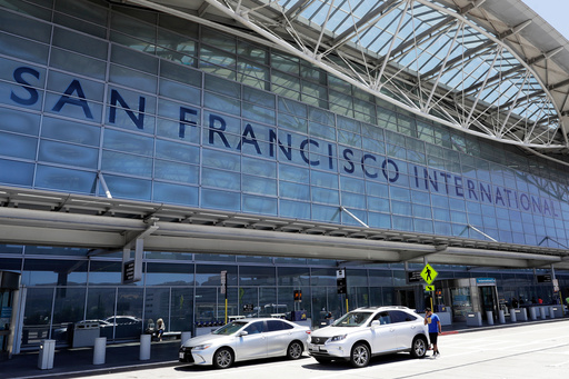 FILE - Vehicles wait outside the international terminal at San Francisco International Airport in San Francisco, July 11, 2017. (AP Photo/Marcio Jose Sanchez, File)