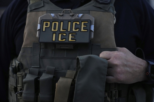 A U.S. Immigration and Customs Enforcement agent takes part in an early morning operation in Park Ridge, Ill., Friday, Sept. 19, 2025. (AP Photo/Erin Hooley)