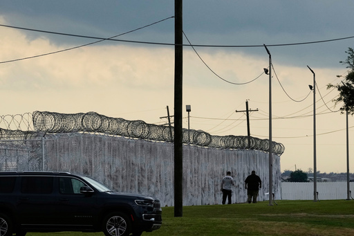FILE - Security walk outside "Camp 57," a facility to house immigration detainees at the Louisiana State Penitentiary in Angola, La., on Sept. 3, 2025. (AP Photo/Gerald Herbert, File)