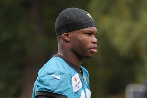 Jacksonville Jaguars wide receiver Travis Hunter (12), attends an NFL football practice at The Grove in Watford, England, Friday, Oct. 17, 2025. (AP Photo/Kin Cheung)
