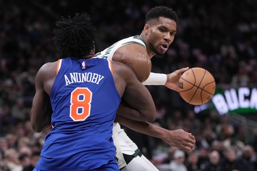 Milwaukee Bucks' Giannis Antetokounmpo tries to get past New York Knicks' OG Anunoby during the second half of an NBA basketball game Tuesday, Oct. 28, 2025, in Milwaukee. (AP Photo/Morry Gash)
