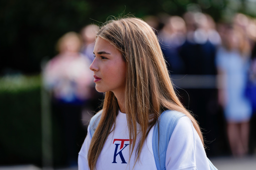 FILE - Kai Trump watches as her grandfather President Donald Trump speaks to reporters before departing the White House, Sept. 26, 2025, in Washington. (AP Photo/Julia Demaree Nikhinson, file)