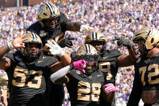 Vanderbilt running back Sedrick Alexander (28) celebrates his touchdown with teammates during the first half of an NCAA college football game against LSU, Saturday, Oct. 18, 2025, in Nashville, Tenn. (AP Photo/George Walker IV)