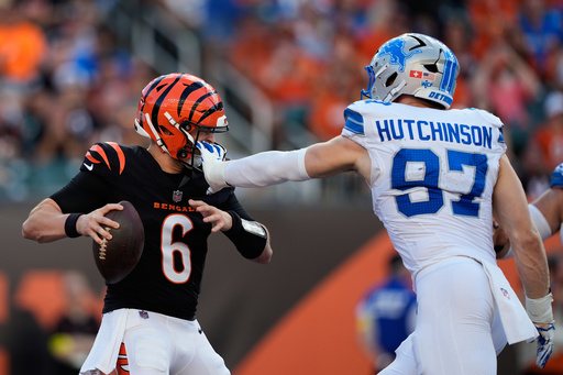 Detroit Lions defensive end Aidan Hutchinson (97) grabs Cincinnati Bengals quarterback Jake Browning (6) by the facemask during the first half of an NFL football game Sunday, Oct. 5, 2025, in Cincinnati. (AP Photo/Carolyn Kaster)