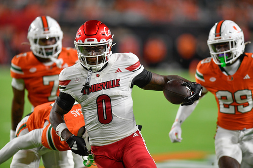 Louisville wide receiver Chris Bell (0) runs for a touchdown during the first half of an NCAA college football game against Miami, Friday, Oct. 17, 2025, in Miami Gardens, Fla. (AP Photo/Michael Laughlin)