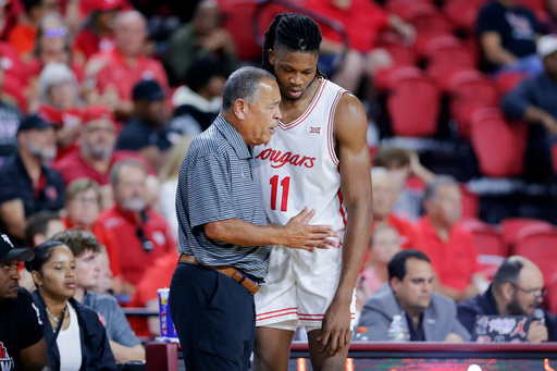 Houston head coach Kelvin Sampson, left, talks with forward Joseph Tugler (11) at the bench during the second half of an NCAA college basketball exhibition game against Mississippi State, Sunday, Oct. 26, 2025, in Rosenberg, Texas. (AP Photo/Michael Wyke)
