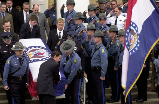 FILE - Members of the Missouri State Highway Patrol salute the body of fellow officer Sgt. Carl ''Dewayne'' Graham Jr., after funeral services March 24, 2005, in Dexter, Mo. (AP Photo/Bill Boyce, File)