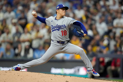 Los Angeles Dodgers pitcher Yoshinobu Yamamoto throws against the Milwaukee Brewers during the fifth inning in Game 2 of baseball's National League Championship Series, Tuesday, Oct. 14, 2025, in Milwaukee. (AP Photo/Ashley Landis)