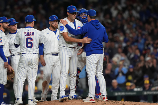Chicago Cubs manager Craig Counsell acknowledges starting pitcher Matthew Boyd (16) while making a pitching change during the fifth inning of Game 4 of baseball's National League Division Series against the Milwaukee Brewers Thursday, Oct. 9, 2025, in Chicago. (AP Photo/Nam Y. Huh)