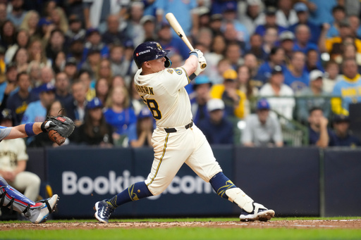 Milwaukee Brewers first baseman Andrew Vaughn (28) hits a solo home run against the Chicago Cubs during the fourth inning of Game 5 of baseball's National League Division Series, Saturday, Oct. 11, 2025, in Milwaukee. (AP Photo/Kayla Wolf)