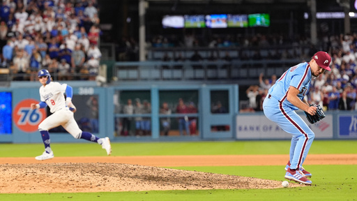 Philadelphia Phillies pitcher Orion Kerkering looks down at a ground ball from Los Angeles Dodgers' Andy Pages before committing a throwing error to home platev and allowing the game-winning run to score during the eleventh inning in Game 4 of baseball's National League Division Series against the Los Angeles Dodgers, Thursday, Oct. 9, 2025, in Los Angeles. (AP Photo/Mark J. Terrill)