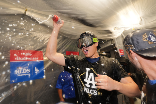 Los Angeles Dodgers' Shohei Ohtani celebrates after his team's win over the Philadelphia Phillies in Game 4 of baseball's National League Division Series Thursday, Oct. 9, 2025, in Los Angeles. (AP Photo/Jae C. Hong)