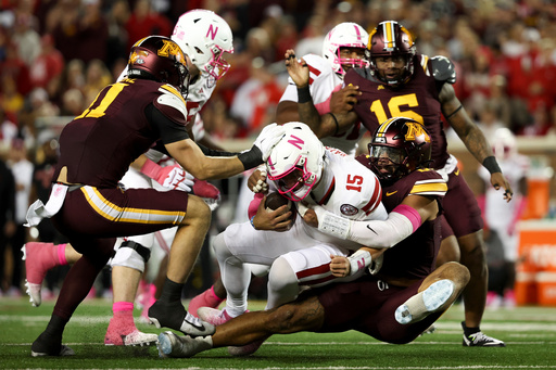 Minnesota defensive lineman Anthony Smith, right, sacks Nebraska quarterback Dylan Raiola (15) during the first half of an NCAA college football game, Friday, Oct. 17, 2025, in Minneapolis. (AP Photo/Ellen Schmidt)