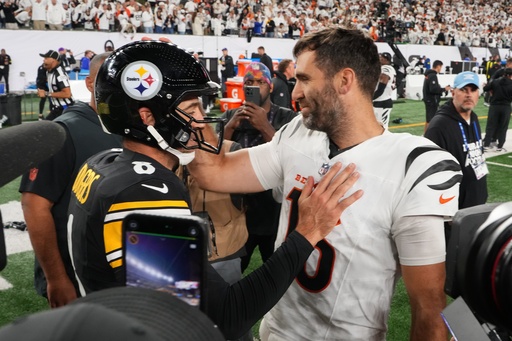 Pittsburgh Steelers quarterback Aaron Rodgers (8) and Cincinnati Bengals quarterback Joe Flacco, right, meet on the field following an NFL football game in Cincinnati, Thursday, Oct. 16, 2025. (AP Photo/Jeff Dean)