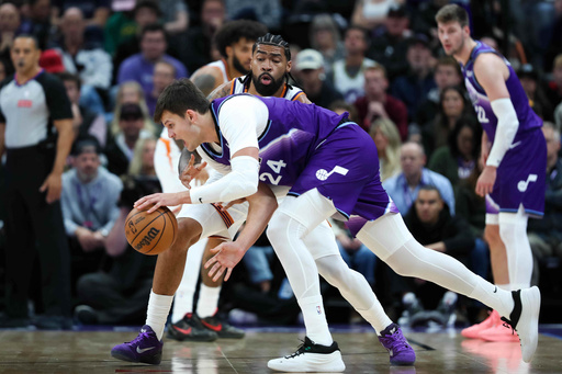 Phoenix Suns center Nick Richards, top, defends against Utah Jazz center Walker Kessler (24) during the first half of an NBA basketball game, Monday, Oct. 27, 2025, in Salt Lake City. (AP Photo/Anna Fuder)