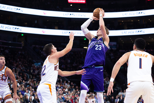Utah Jazz forward Lauri Markkanen (23) shoots over Phoenix Suns guard Collin Gillespie (12) during the second half of an NBA basketball game, Monday, Oct. 27, 2025, in Salt Lake City. (AP Photo/Anna Fuder)