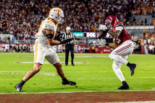 Alabama defensive back Zabien Brown (2) grabs an interception meant for Tennessee tight end Miles Kitselman (87) and returns it 99 yards for a pick-six touchdown on the final play of the first half during an NCAA college football game, Saturday, Oct. 18, 2025, in Tuscaloosa, Ala. (AP Photo/Vasha Hunt)