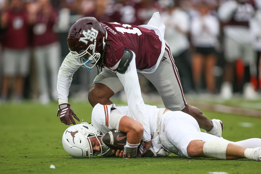 Mississippi State linebacker Derion Gullette, top, sacks Texas quarterback Arch Manning, bottom, during the first half of an NCAA college football game in Starkville, Miss., Saturday, Oct. 25, 2025. (AP Photo/James Pugh)