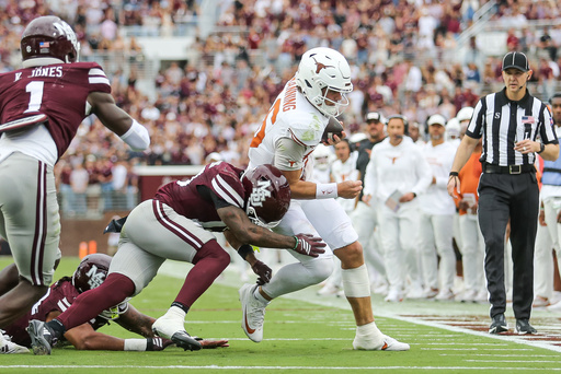 Texas quarterback Arch Manning, center right, runs out of bounds against Mississippi State safety Jahron Manning, center left, during the first half of an NCAA college football game in Starkville, Miss., Saturday, Oct. 25, 2025. (AP Photo/James Pugh)