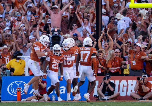 Texas punt returner Ryan Niblett (21) celebrates with teammates after returning a punt for a touchdown during the second half of an NCAA college football game against Oklahoma, Saturday, Oct. 11, 2025, in Dallas. (AP Photo/Jeffrey McWhorter)